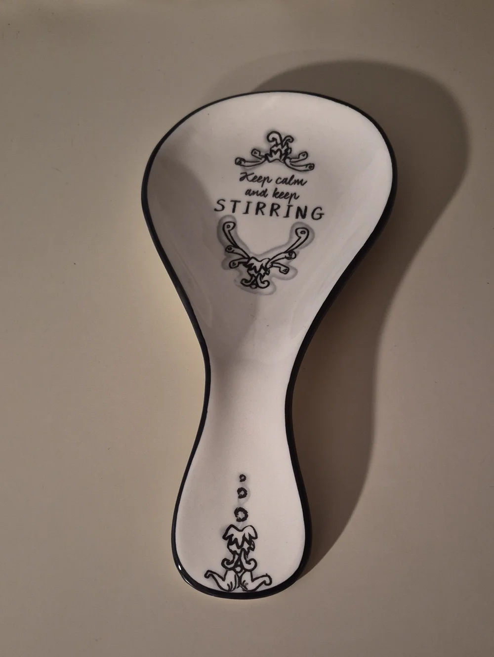 Keep Calm and Keep Stirring Ceramic Spoon Rest - White with Black Trim